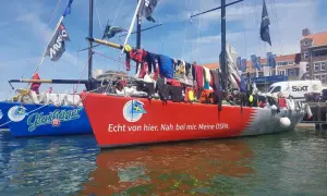 Segelboote im Hafen, Wäsche trocknet an Bord. Michael Illbrucks Boot "Meine OSPA" mit rotem Rumpf und Schriftzug.