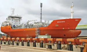 Orange product tanker "BRAHMS" in dry dock, ready for maintenance.