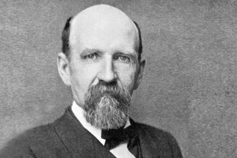Porträt von Joshua Slocum, dem ersten Einhandsegler, mit Bart und Anzug.